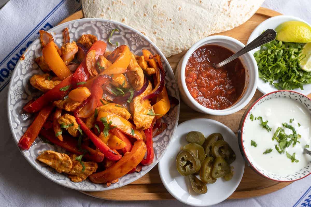 air fryer fajitas served with salsa, coriander, sour cream and tortilla wraps