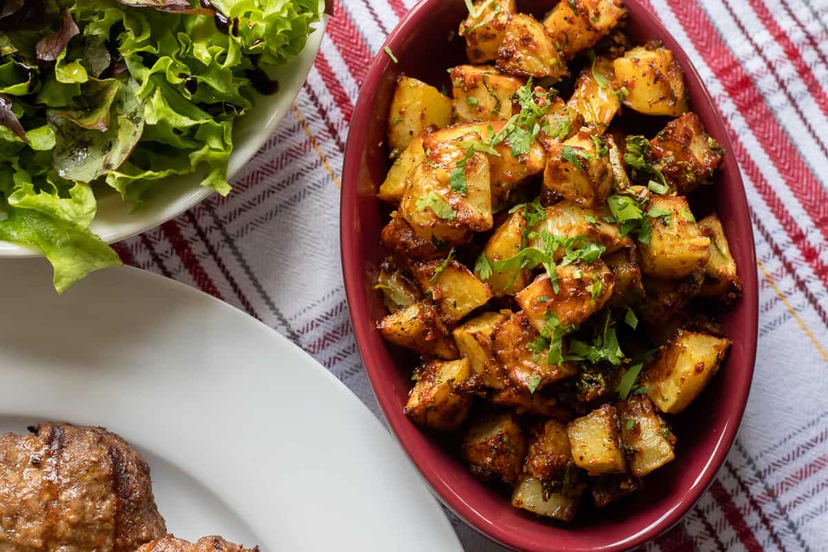 Batata harra - Lebanese potatoes are served with salad and koftas