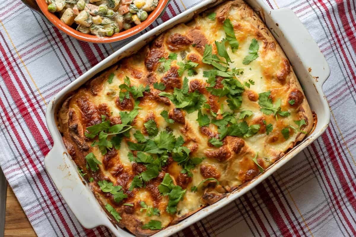 white chicken enchiladas topped with fresh coriander