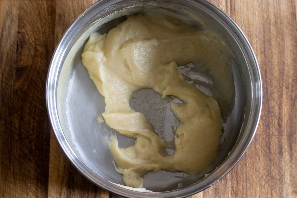 slowly adding the chicken broth while whisking vigorously