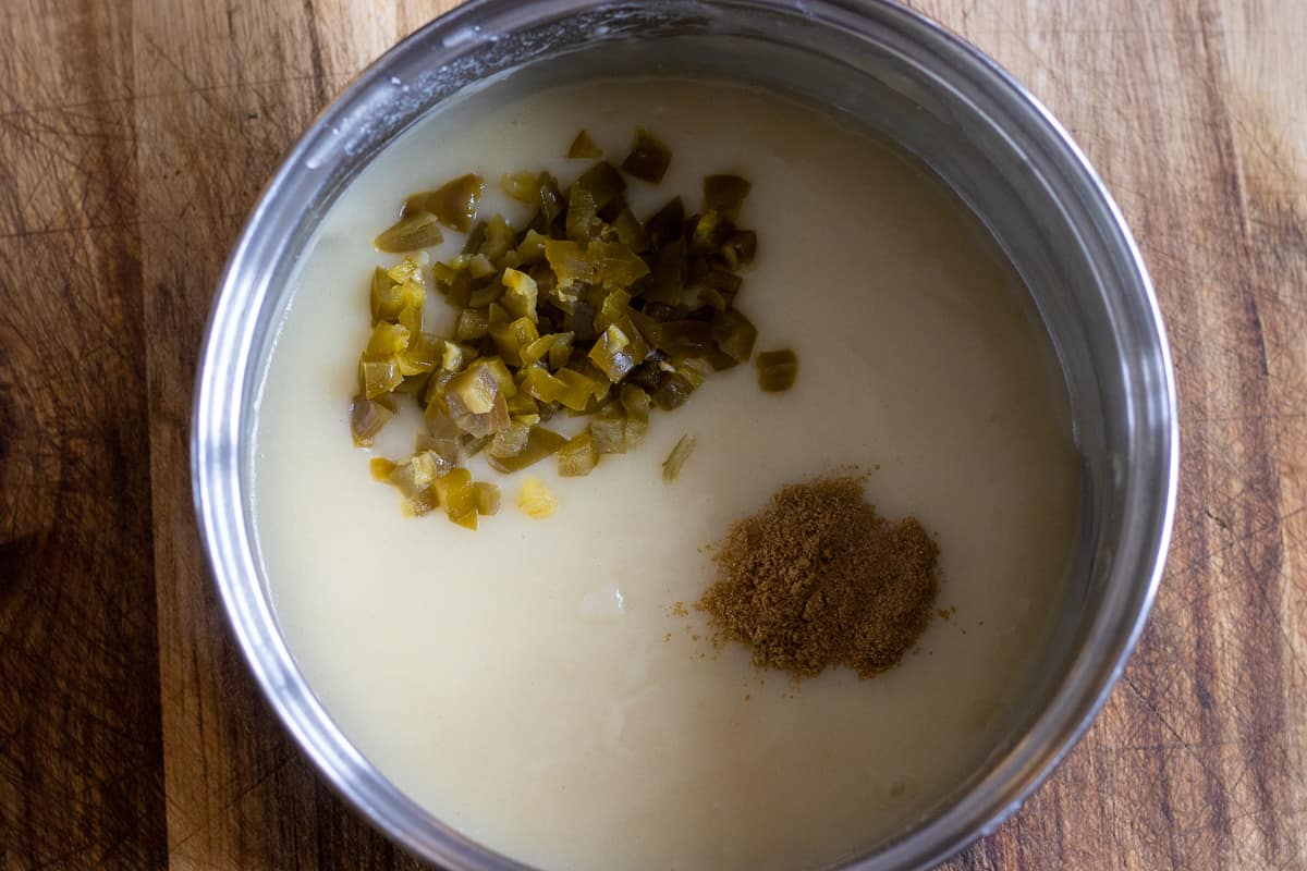 diced jalapeños and seasoning are added to the sauce