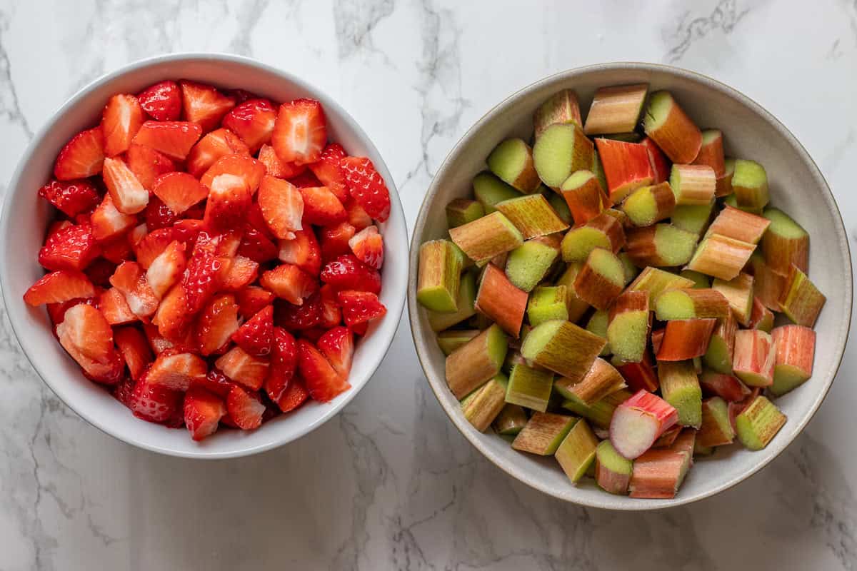 Chopped strawberries and rhubarb in bowls.