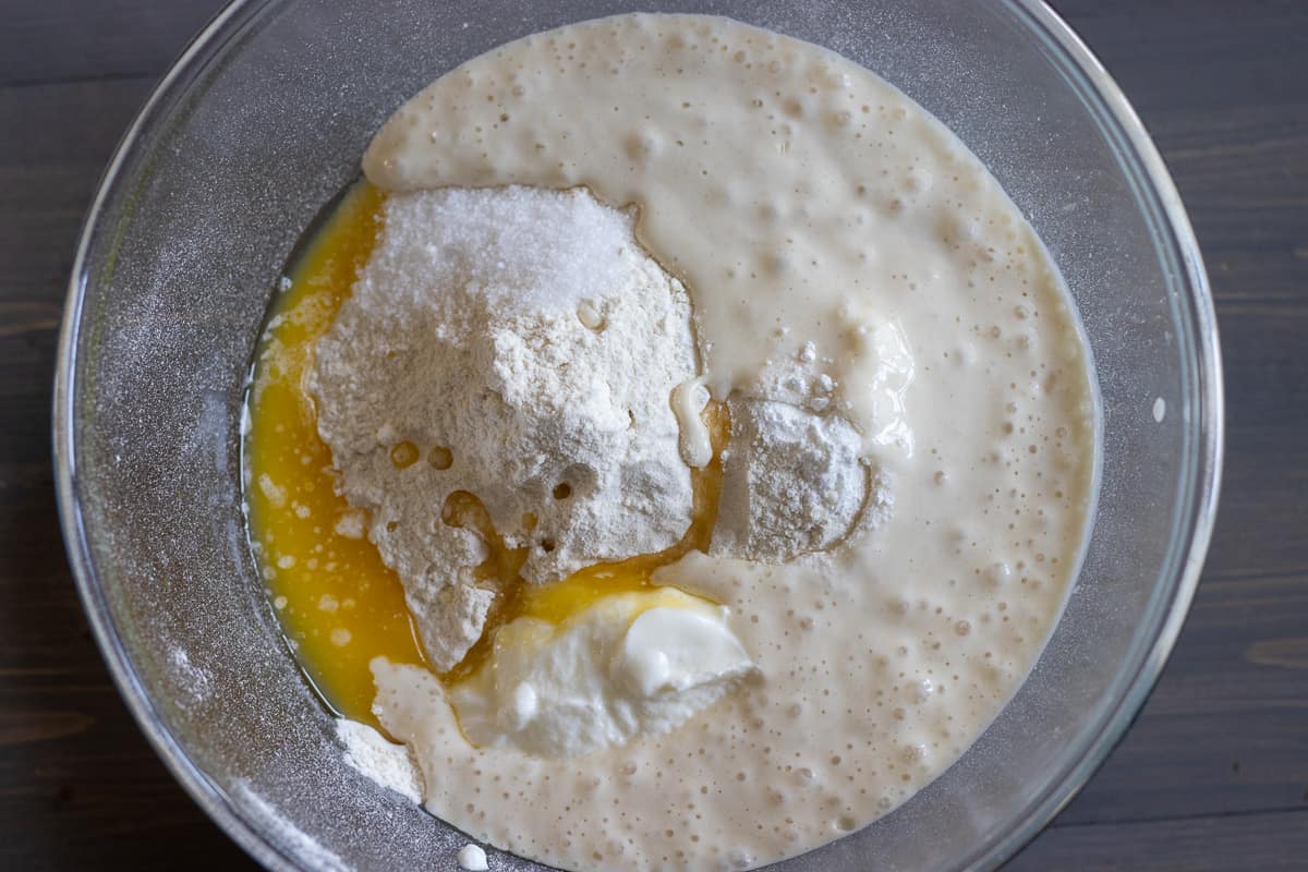 flour, water, yogurt, melted butter, salt, and baking powder are placed in a bowl