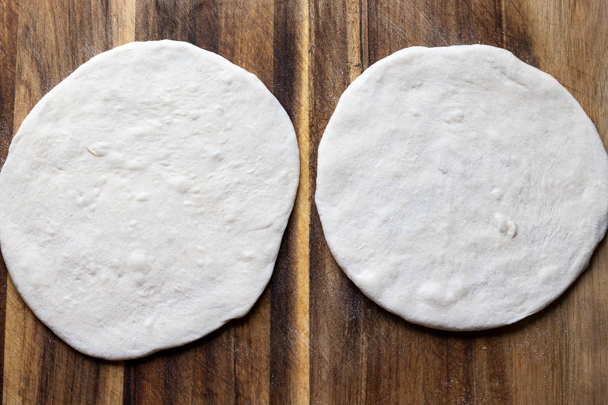 2 rolled out dough balls ready to cook