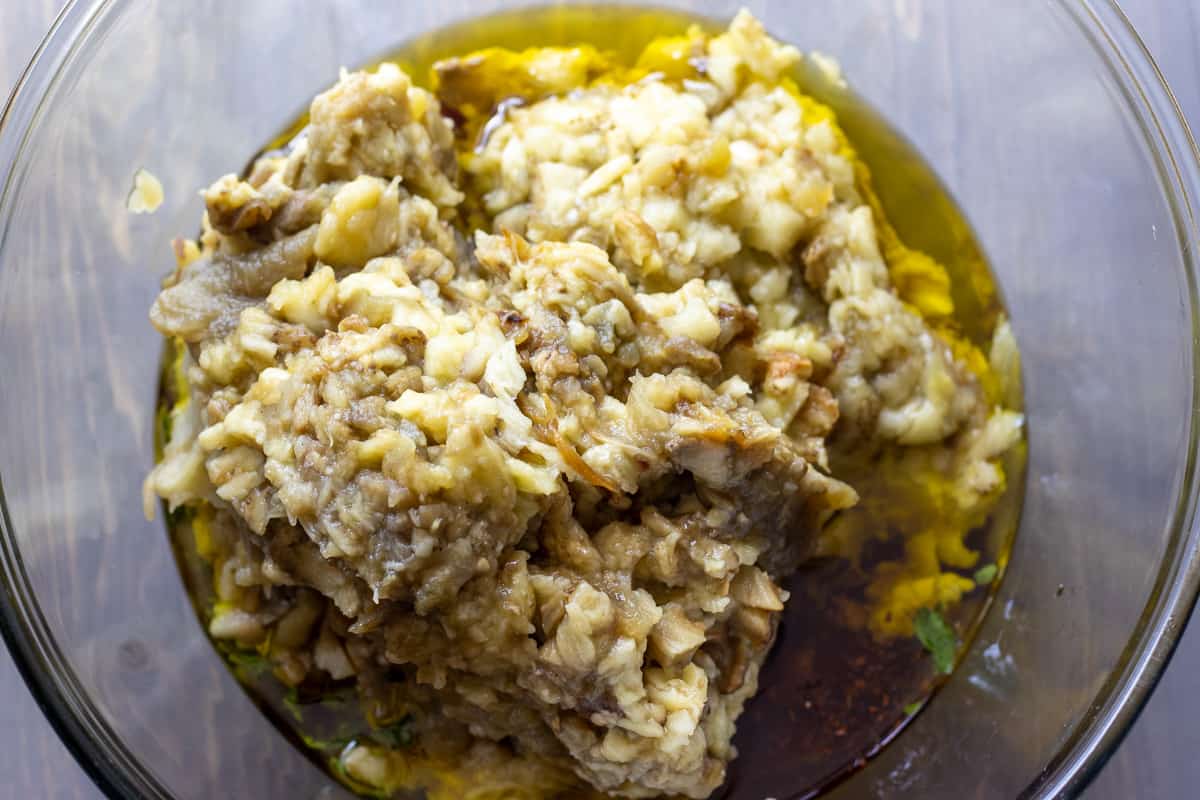 chopped eggplants are placed in a bowl along with the olive oil