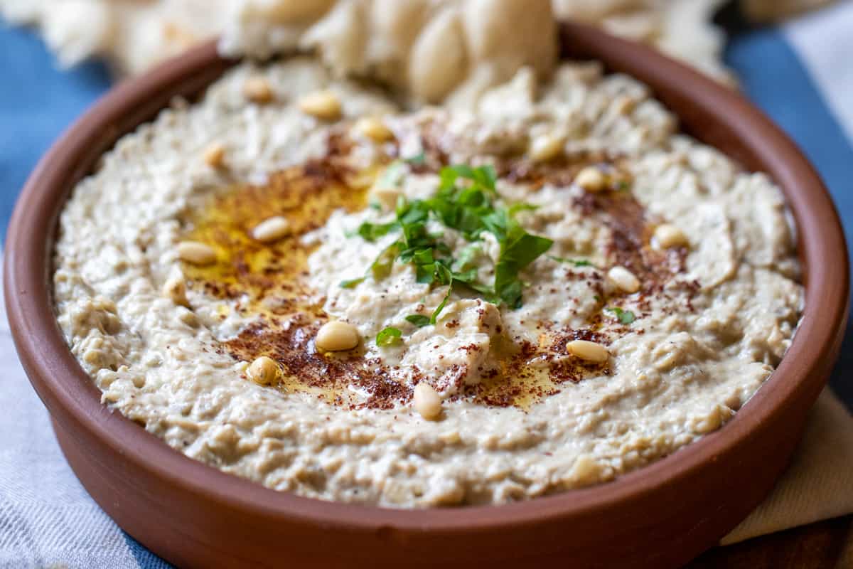 Mutabal is garnished with chopped parsley and pine nuts