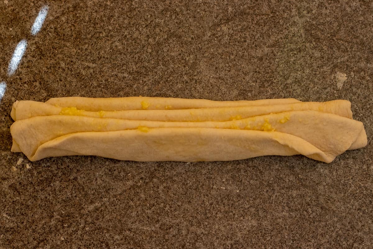 the dough circle has been plied into an accordion shape