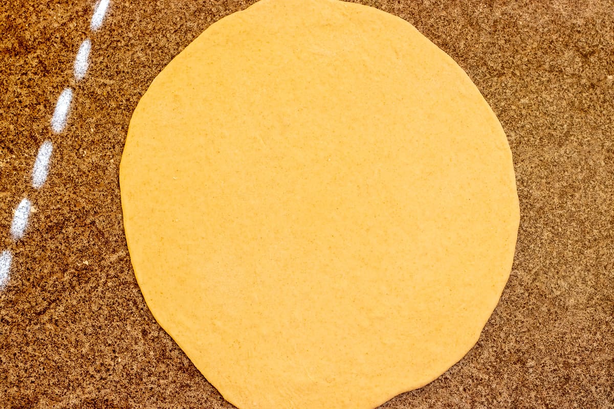 a dough ball rolled out into a circle
