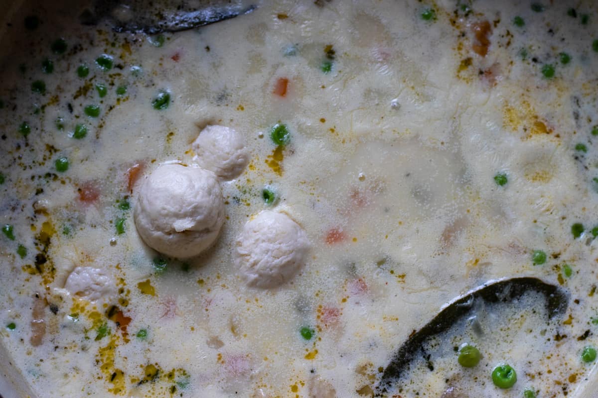 dumplings are dropped into the soup