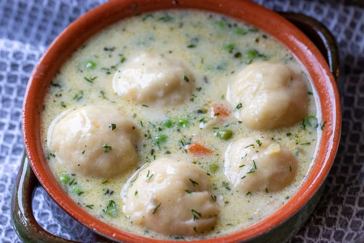 the soup is poured into a bowl with a ladle