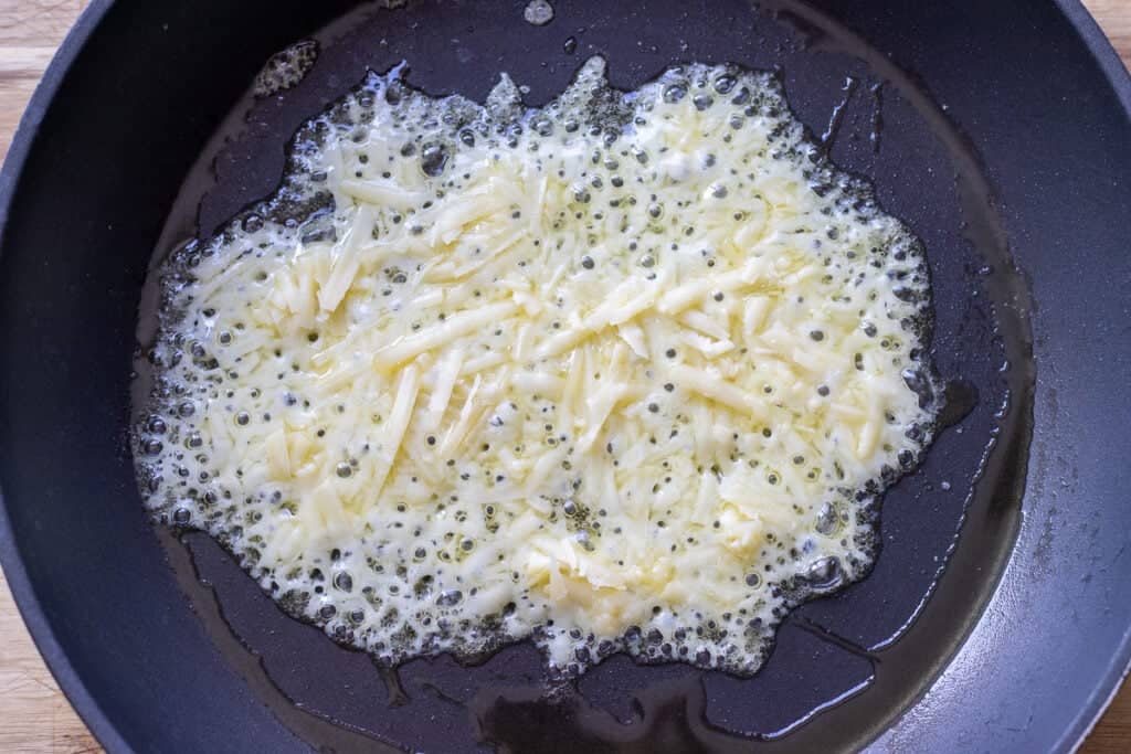 Cheese is melted in a pan.