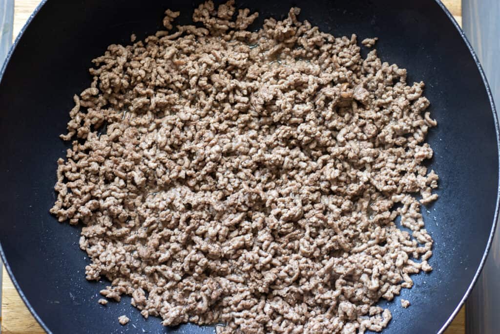 Browning the ground beef in a pan.