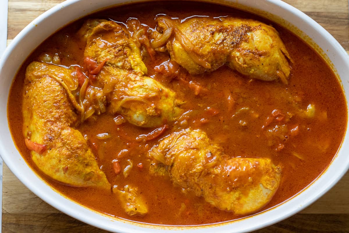 chicken legs are cooked until fork tender in saffron sauce