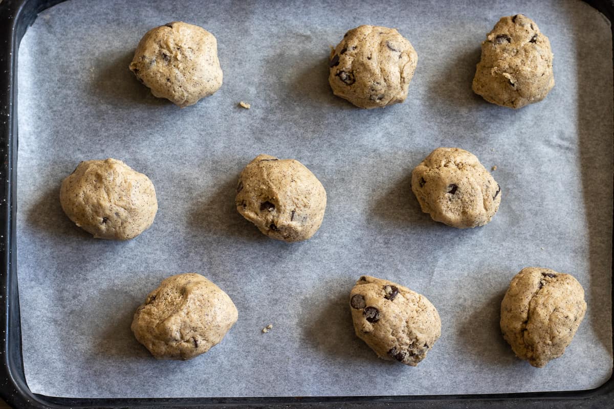 the cookie dough has been scooped on a baking sheet