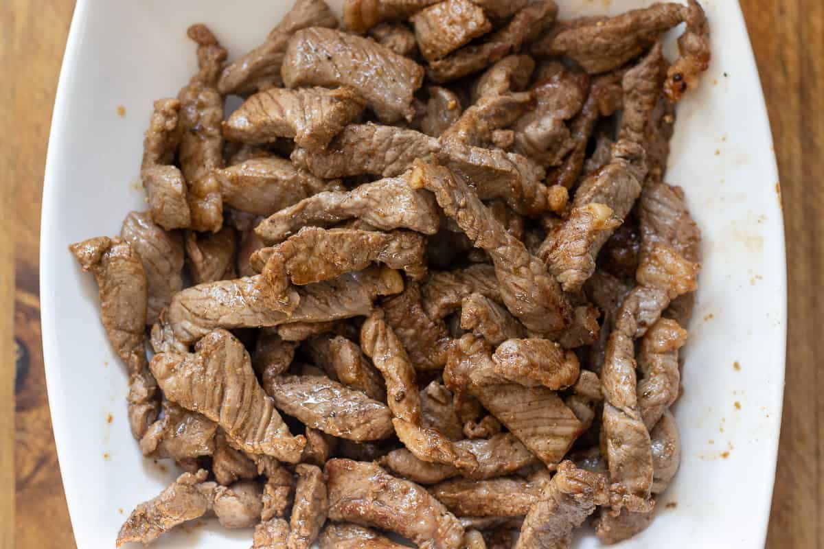 sautéed beef pieces are placed on a plate