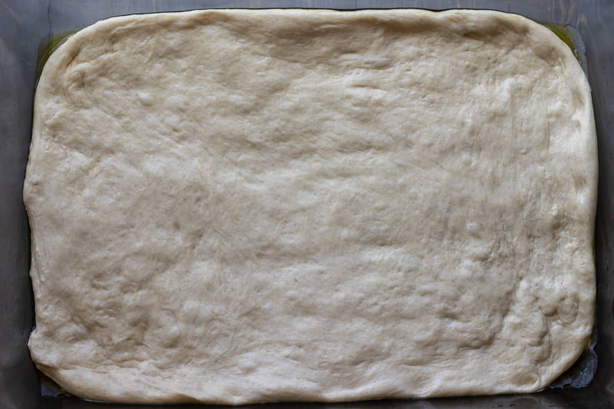 the dough is lightly pressed to fit in the baking dish