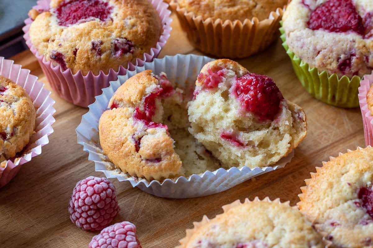 a raspberry muffin is cut in half