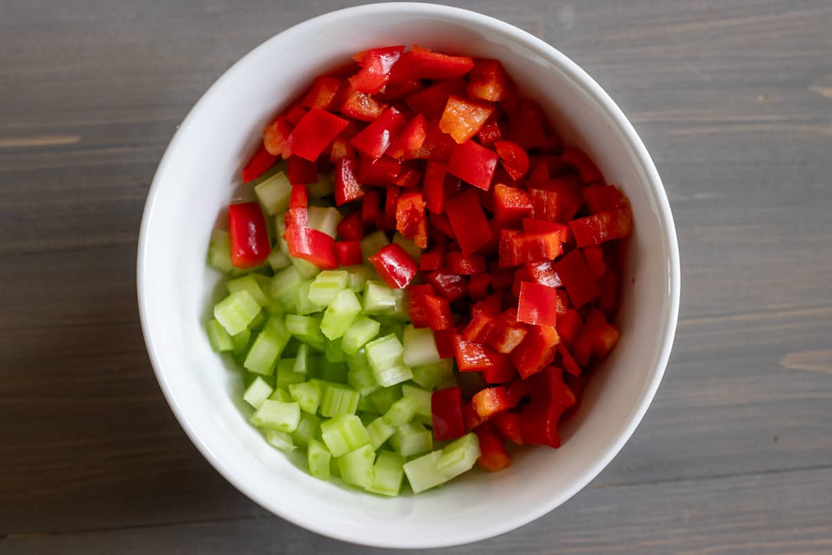 diced celery and red pepper placed in a bowl