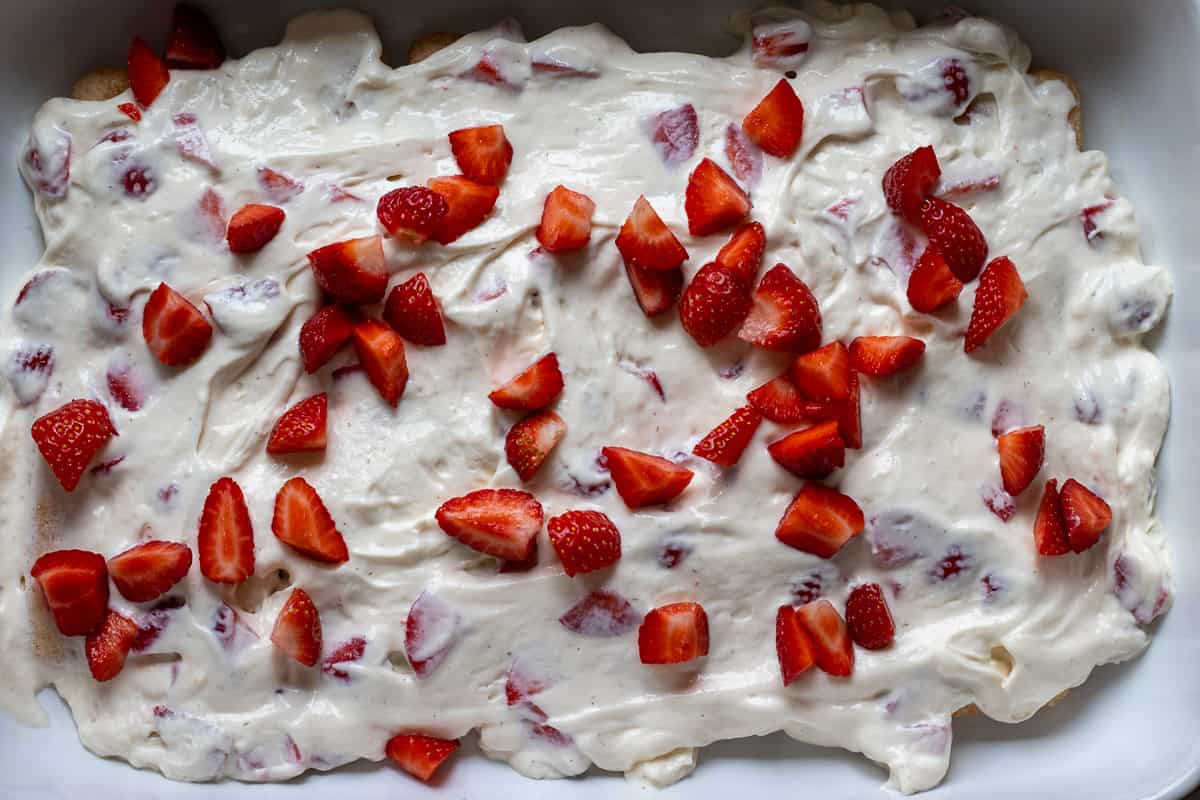 half of the mascarpone mixture is spread on top of the ladyfingers