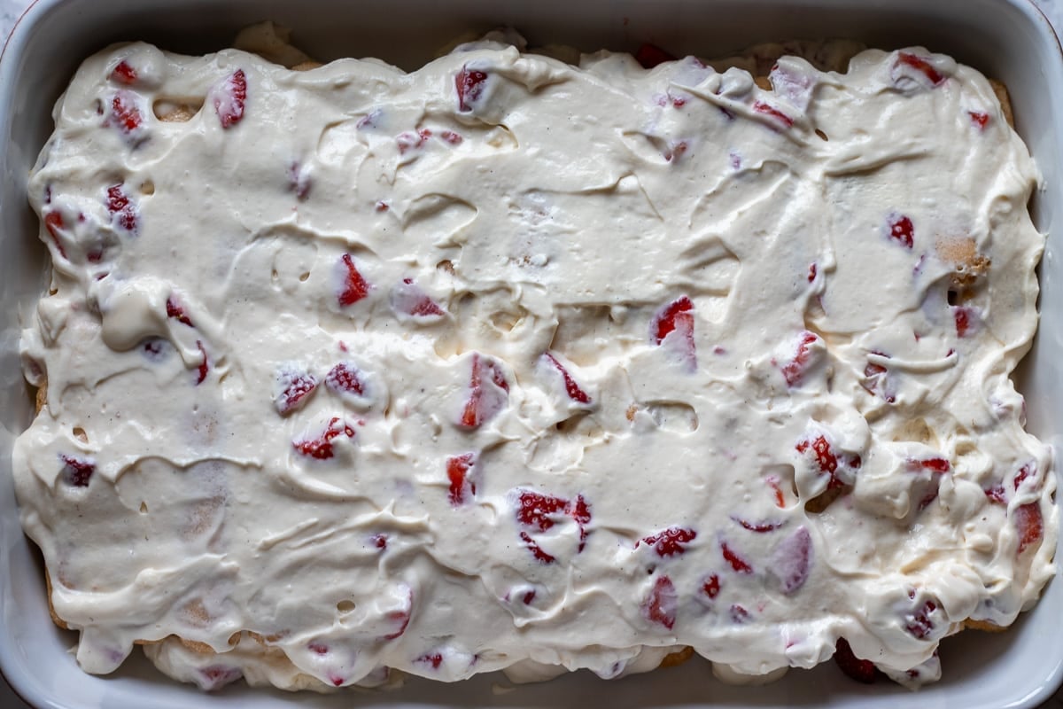second layer of mascarpone cream is spread on top of ladyfingers