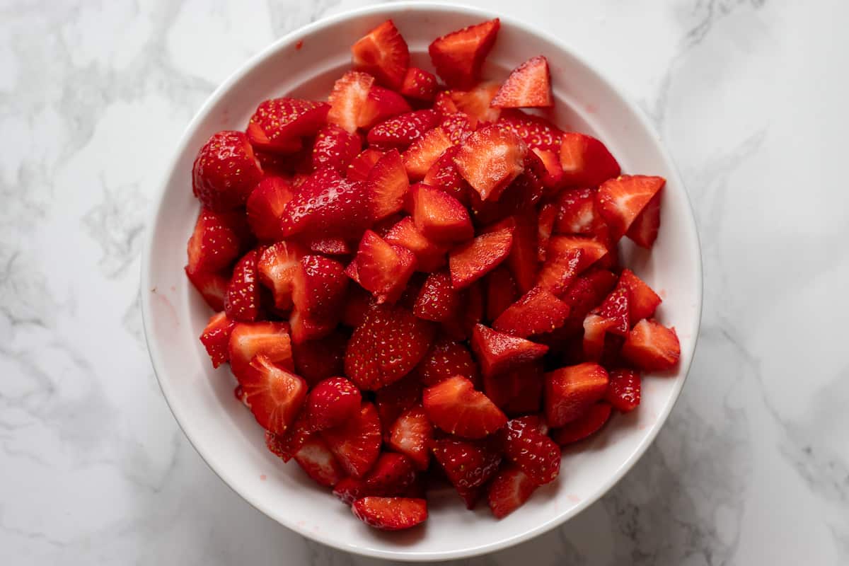 strawberries are washed and chopped for tiramisu dessert