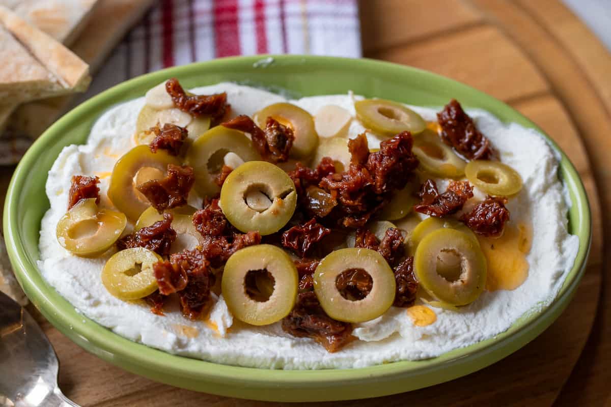 labneh cheese garnished with sliced olives