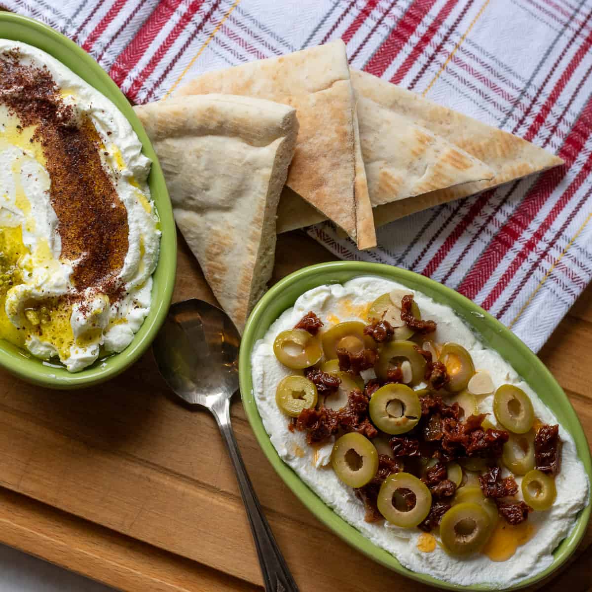 labneh cheese served with pita bread and garnished with sliced olives