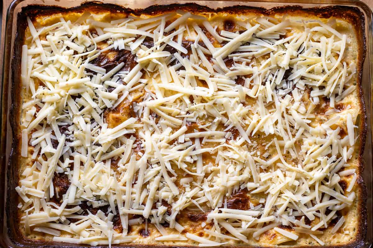 grated cheese scattered over partly baked dauphinoise