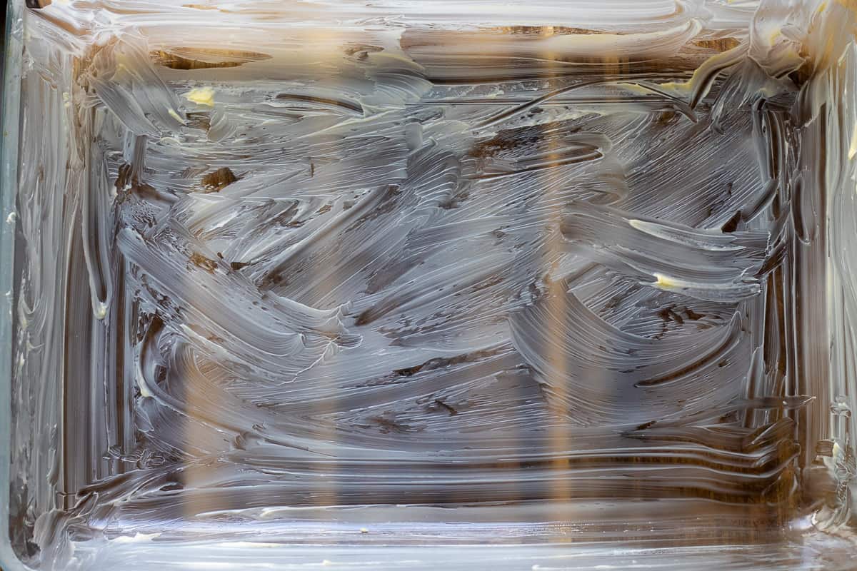 a glass baking dish is lightly greased with butter