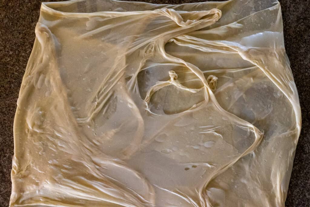 stretched dough is shaped into an envelope