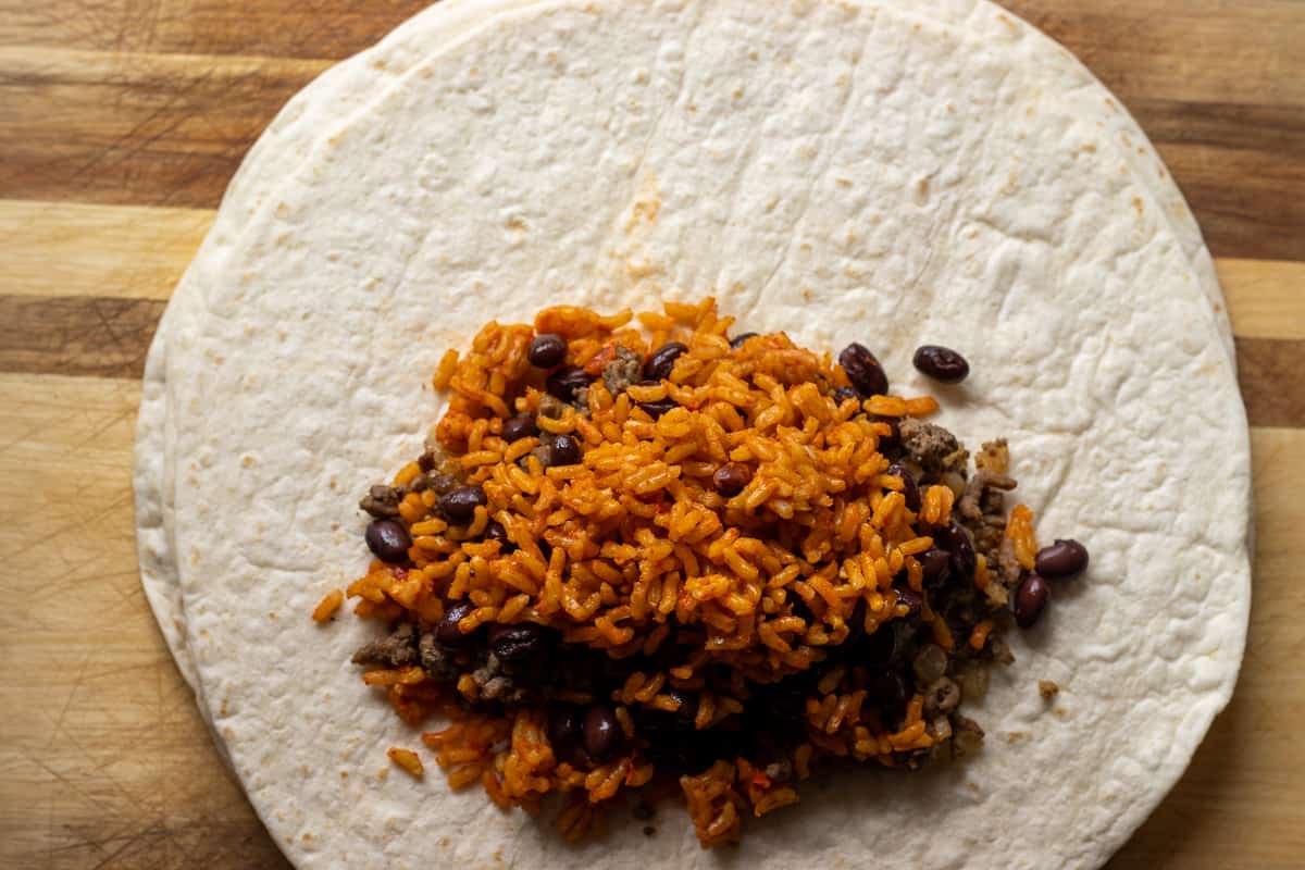 Mexican rice is added to the black beans