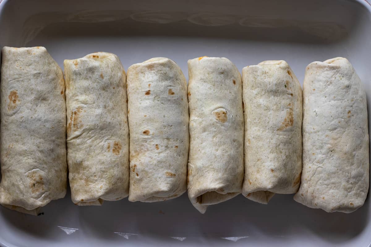 burritos are placed in an one dish seam side down