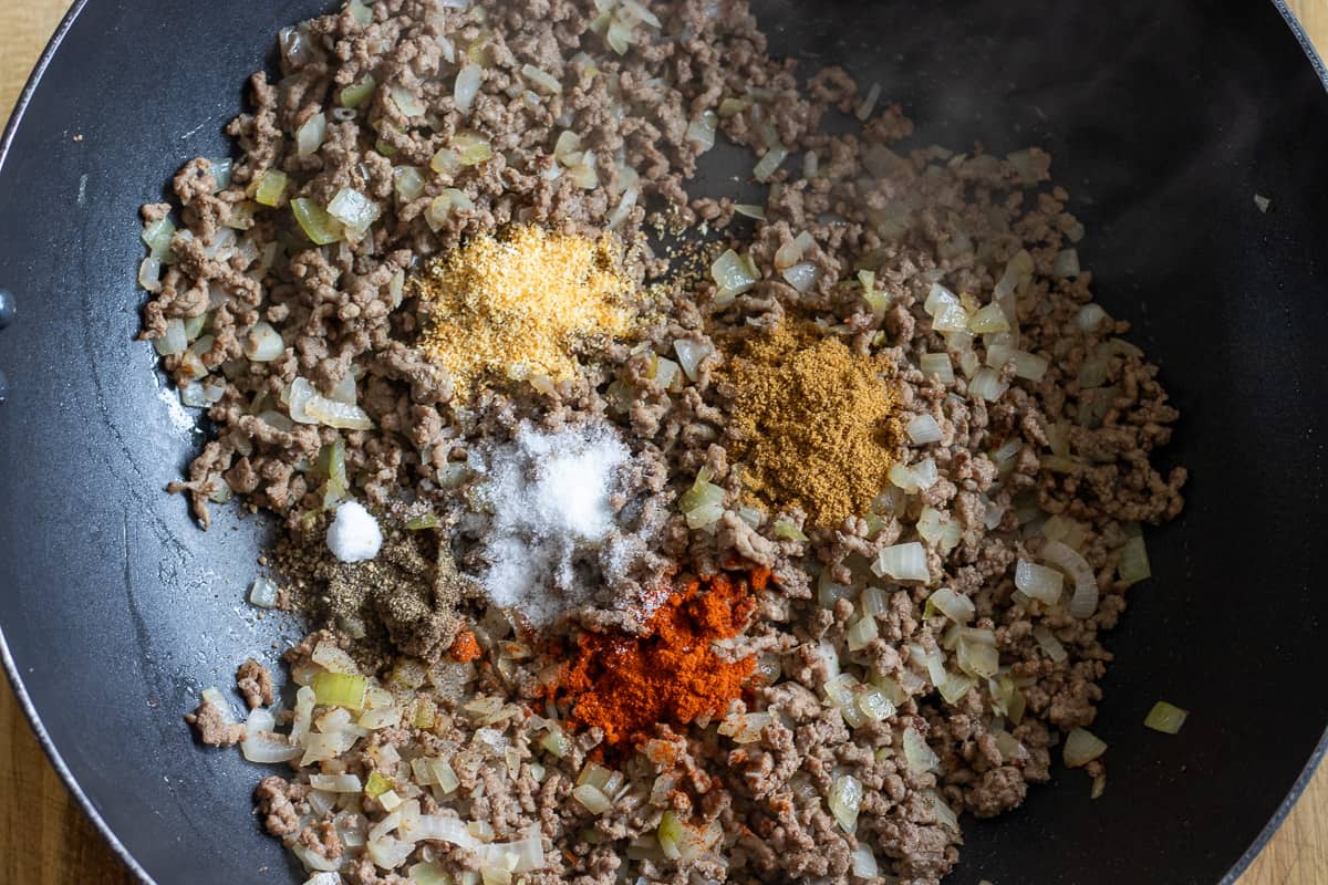 taco seasoning is added to the ground beef and onions