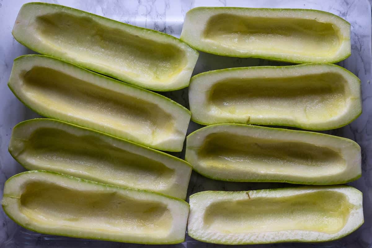 zucchini boats are placed in a baking dish