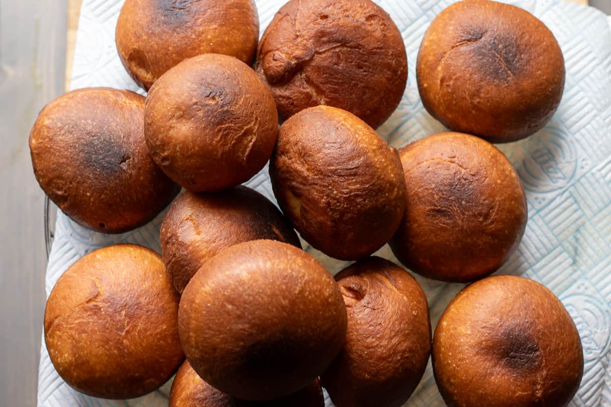 fried doughnuts are placed on a paper towel get rid of excess oil