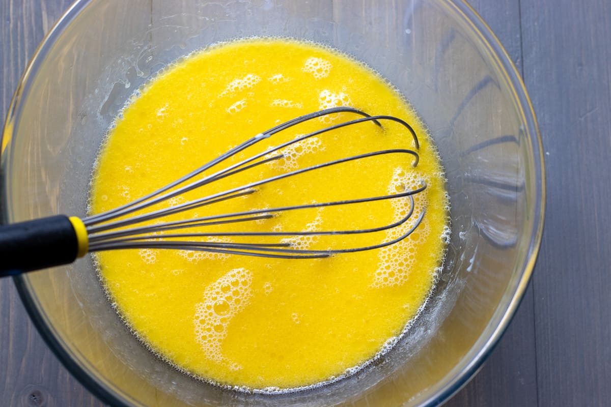 melted butter, eggs, and milk are whisked together n a bowl