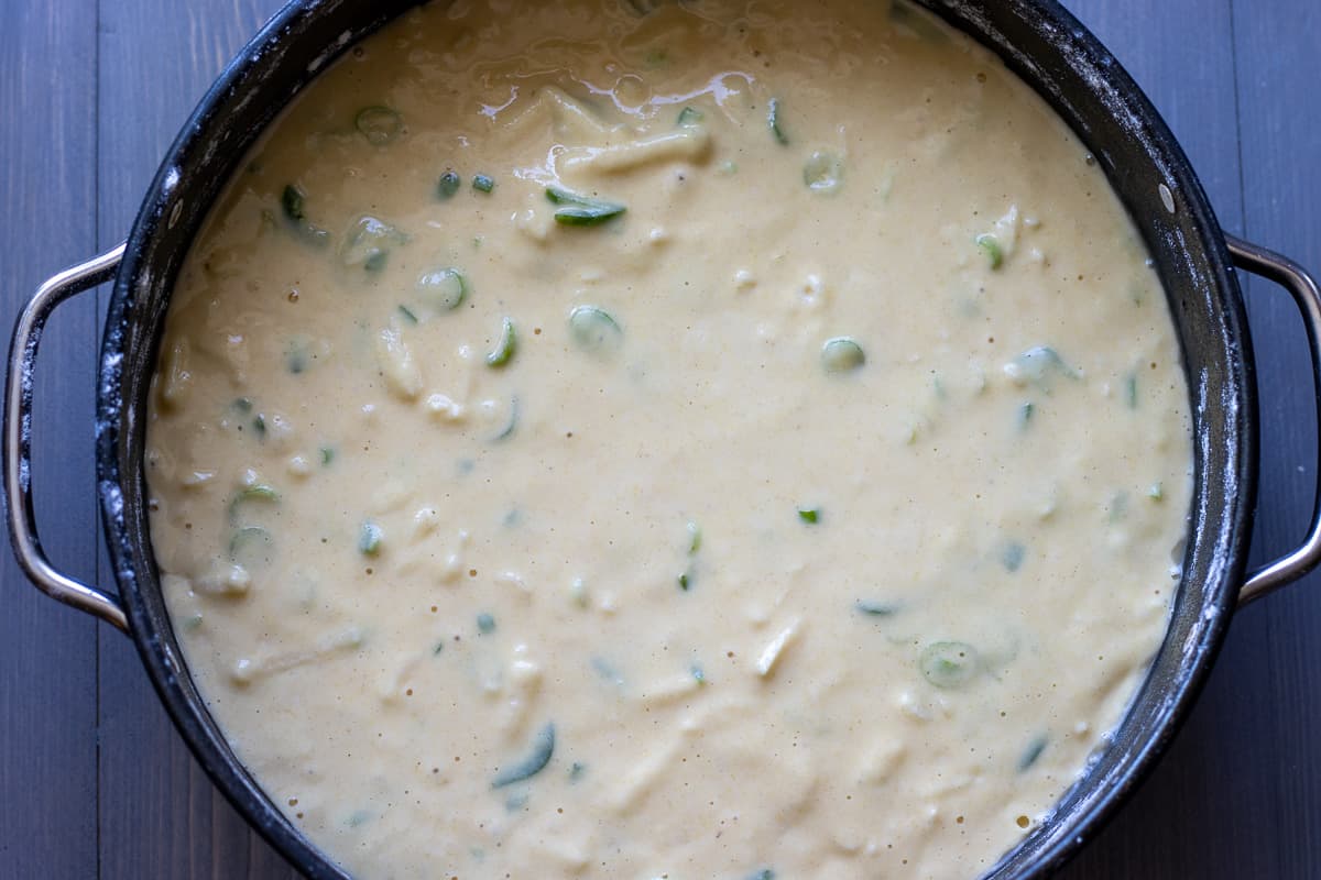 the batter mixture is poured in a cake tin