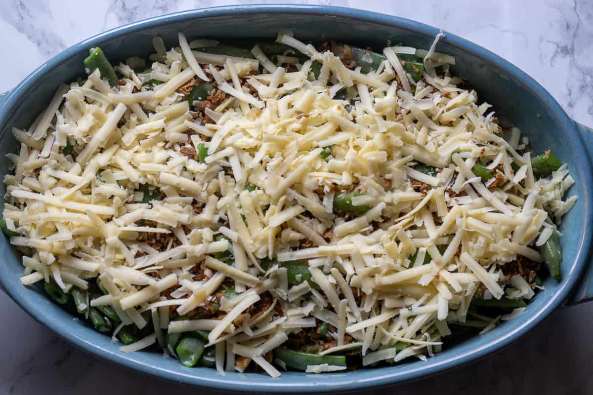 green beans are covered with fried onions and grated cheese