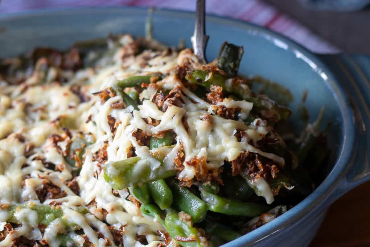 serving green bean casserole with a spoon