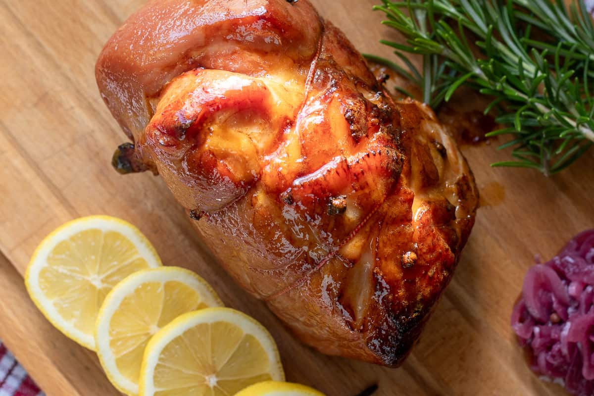 honey glazed ham served with rosemary and 4 lemon slices