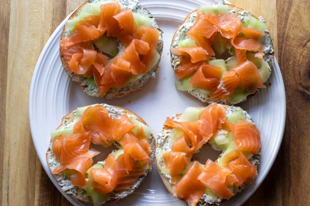 smoked salmon slices are placed on top of cucumber slicers