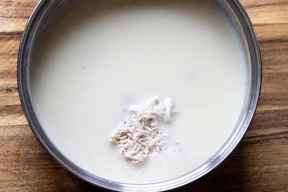 shredded chicken pieces are added to the custard