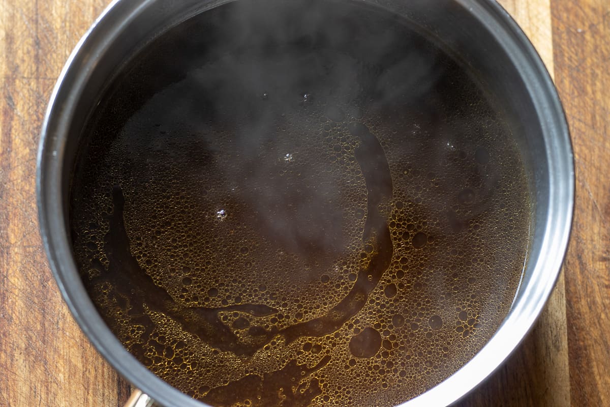 Simmering the gravy to reduce it down.