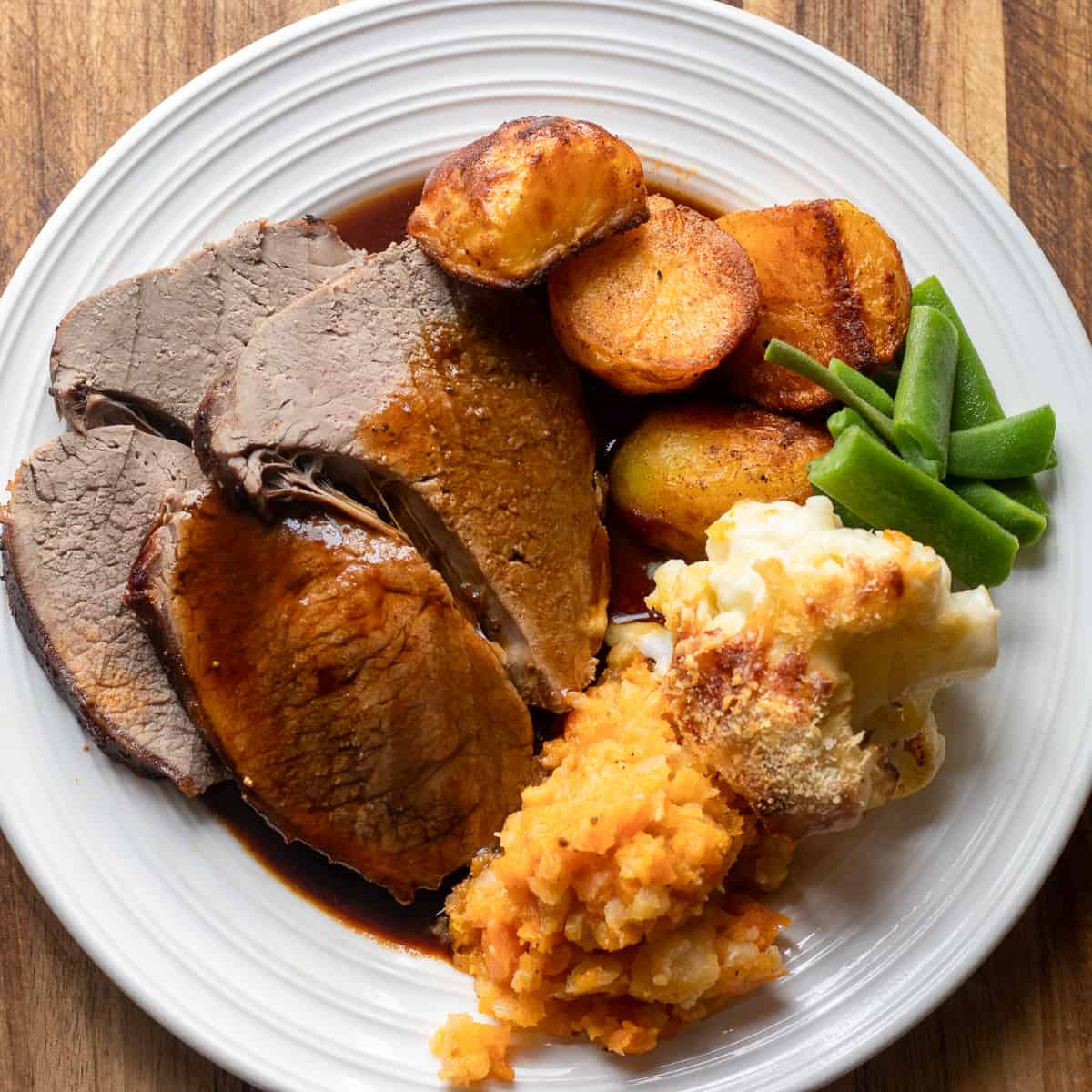 2 slices of beef sirloin served with side dishes and gravy.
