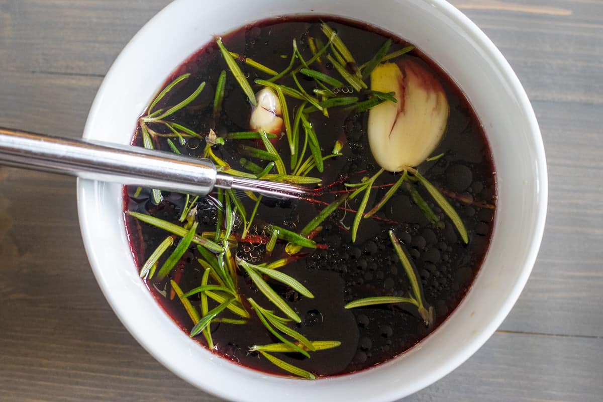 The marinade for the beef in a whitre bowl.