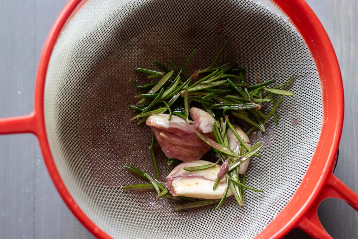 The marinade is strained through a sieve.