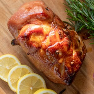 baked honey glazed ham served on a wooden plate