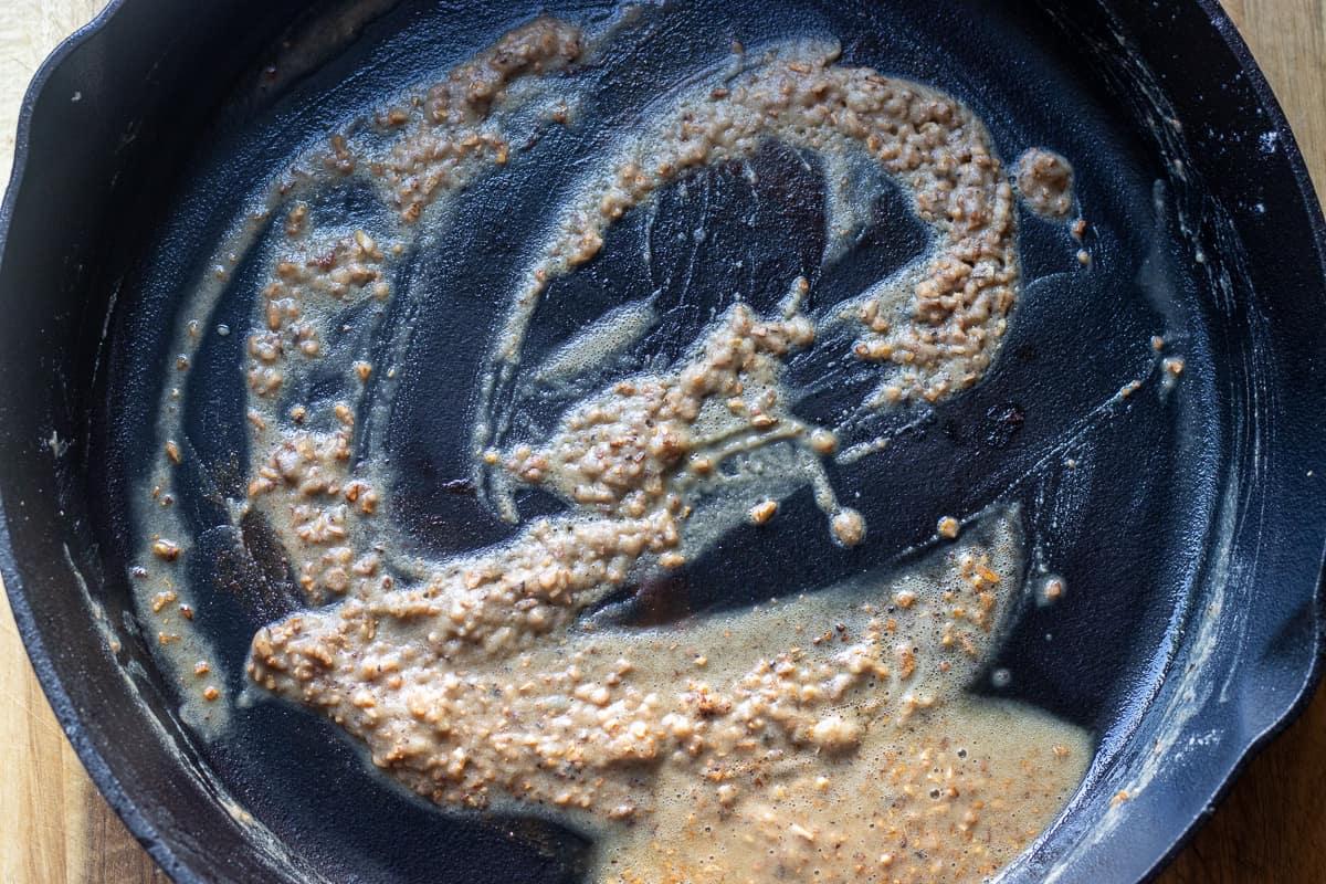 the flour and garlic is added to the oil to create a roux