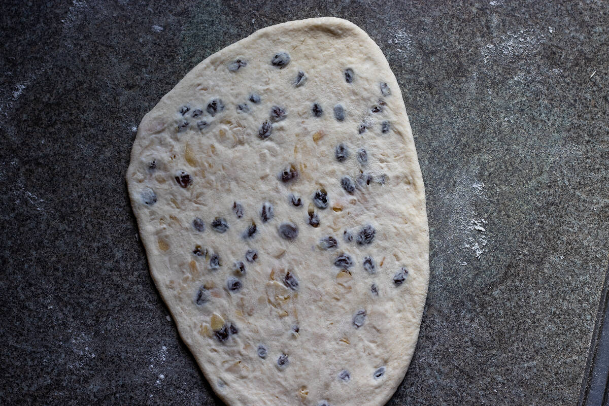 the stuffed dough ball is shaped into a naan bread