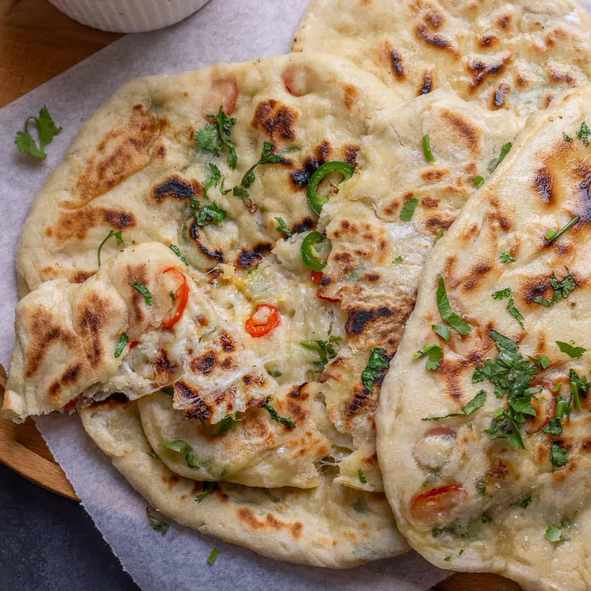 A plate with three flatbreads on it
